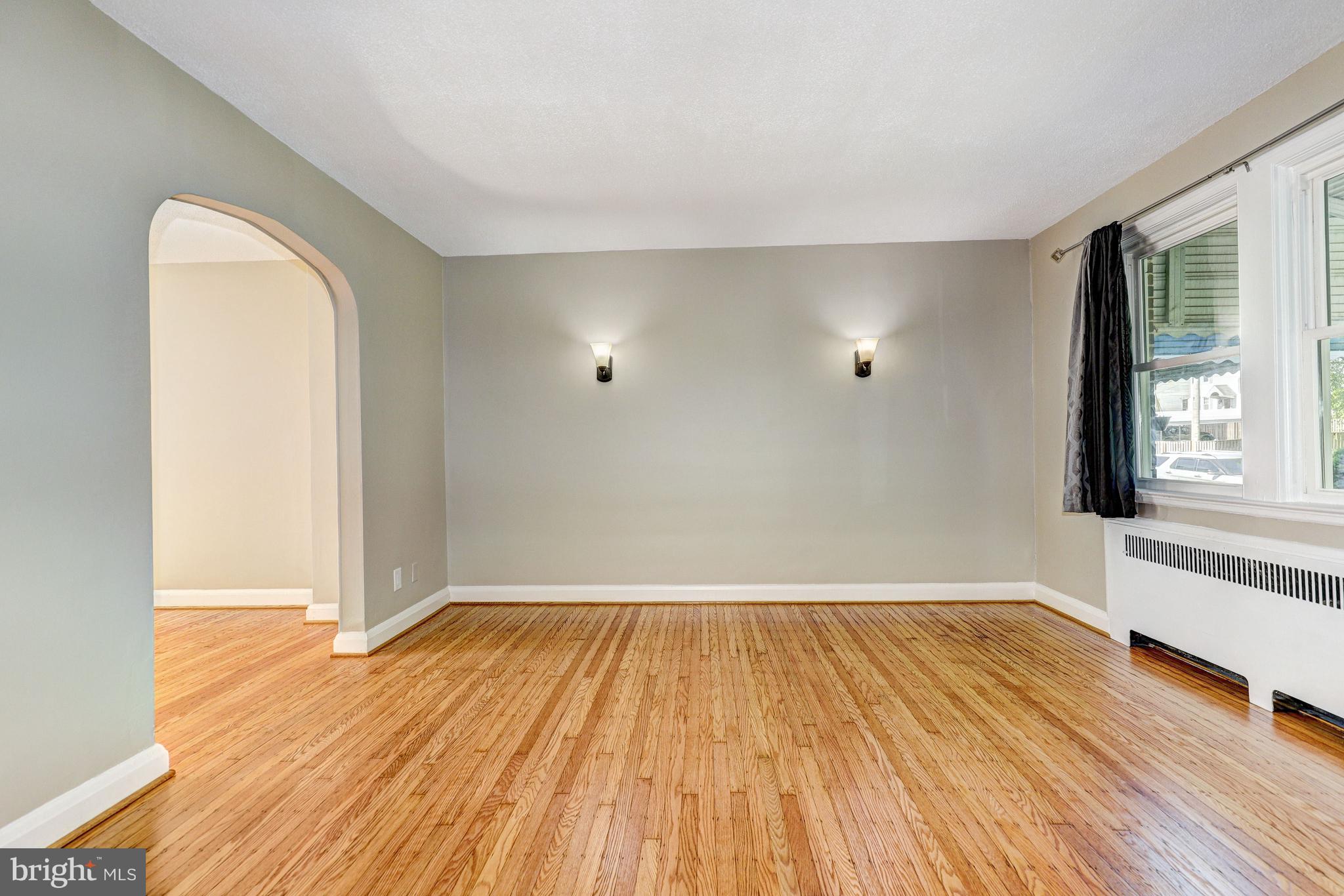 5203 Garmouth Road Baltimore, MD 21229 - Photo 3 of 42 Living Room | Hardwood Floors | Arched Doorway