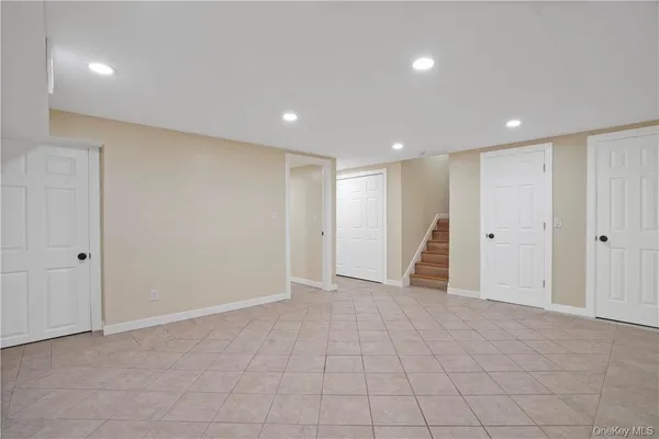 a view of empty room with wooden floor and fireplace