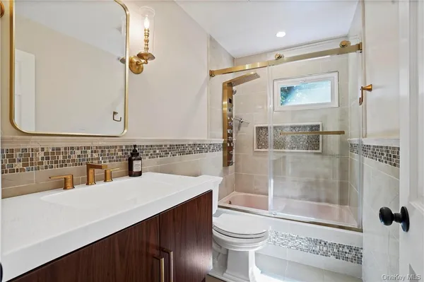 a bathroom with a sink mirror vanity and toilet