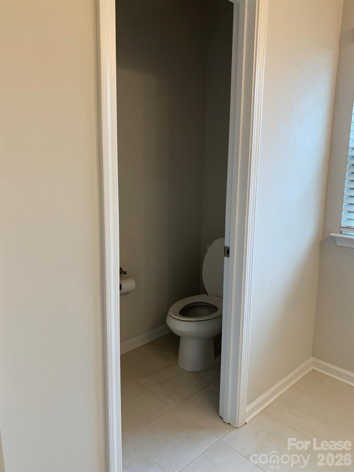 2143 Stevens Mill Road Matthews, NC 28104 - Photo 20 of 39 a white toilet sitting next to a white cabinet