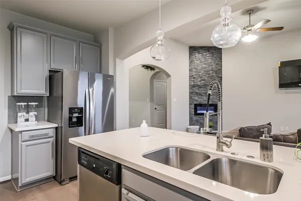 a kitchen with stainless steel appliances a sink a refrigerator and a stove