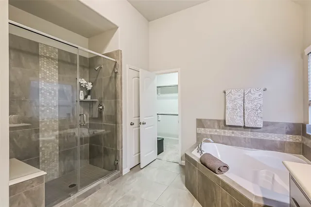 a bathroom with a tub and a shower