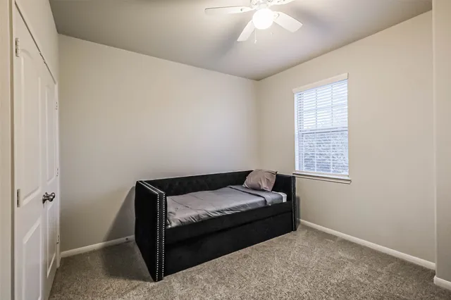 a bedroom with a bed and a window