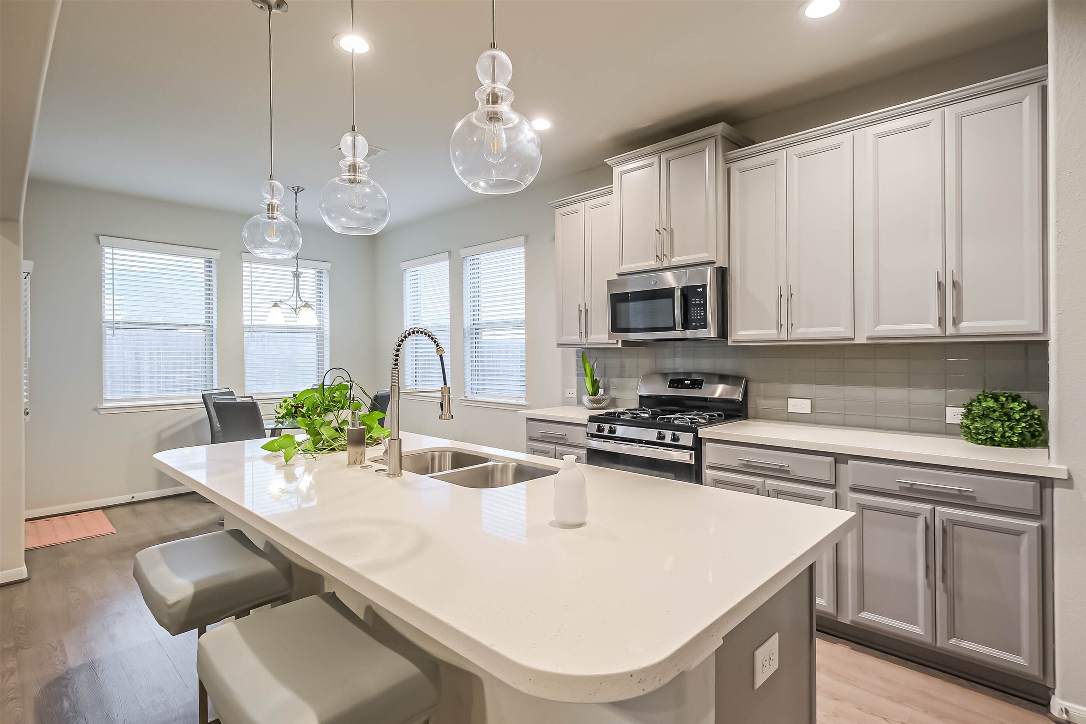 6214 Scott Way Rosenberg, TX 77471 - Photo 7 of 19 a kitchen with stainless steel appliances granite countertop a sink a stove a microwave a refrigerator cabinets and dining table