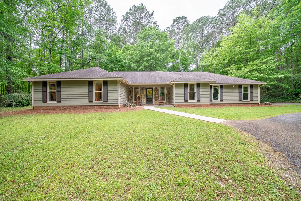 111 Stoneridge Road Cataula, GA 31804 - Photo 1 of 45 a front view of a house with a garden and lake view