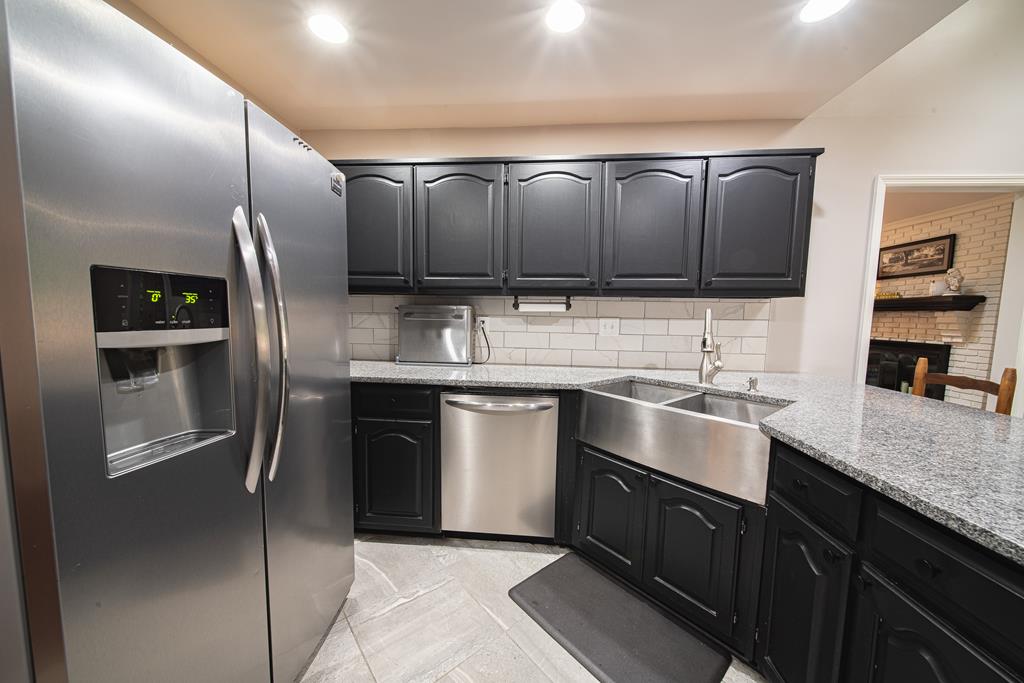 111 Stoneridge Road Cataula, GA 31804 - Photo 14 of 45 a kitchen with stainless steel appliances granite countertop a sink stove and refrigerator