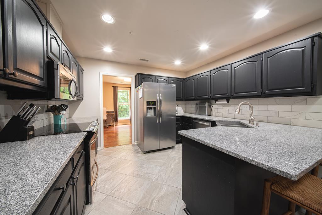 111 Stoneridge Road Cataula, GA 31804 - Photo 17 of 45 a kitchen with stainless steel appliances granite countertop a sink stove and refrigerator