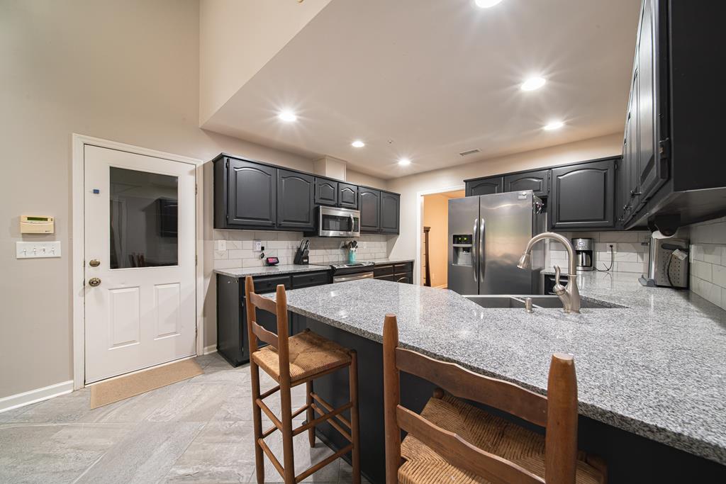 111 Stoneridge Road Cataula, GA 31804 - Photo 18 of 45 a kitchen with stainless steel appliances granite countertop a sink refrigerator and cabinets