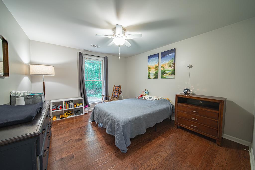 111 Stoneridge Road Cataula, GA 31804 - Photo 19 of 45 a bedroom with a bed and a dresser