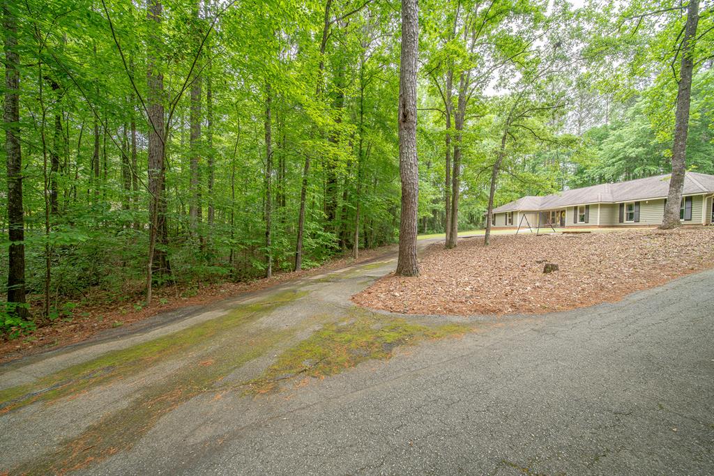 111 Stoneridge Road Cataula, GA 31804 - Photo 2 of 45 a view of an house with backyard and trees