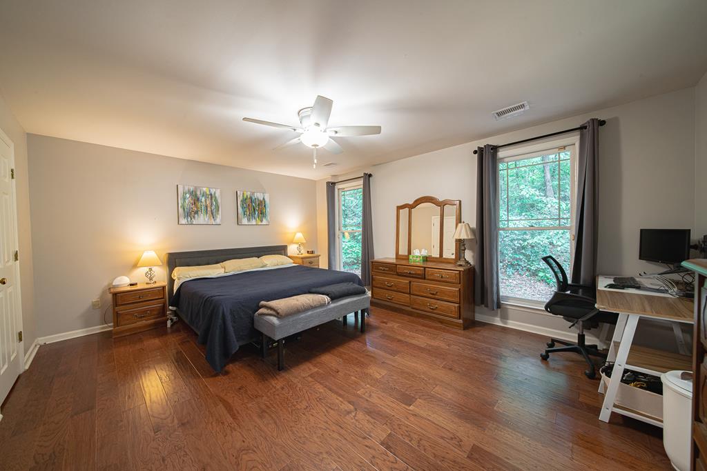 111 Stoneridge Road Cataula, GA 31804 - Photo 25 of 45 a bedroom with a bed and a chandelier