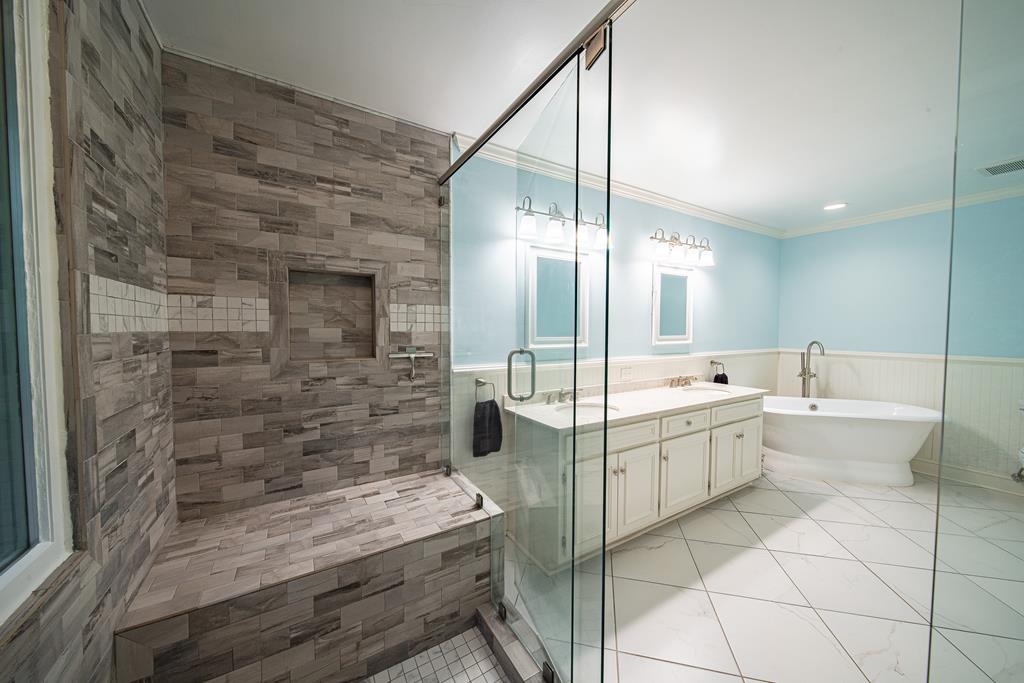 111 Stoneridge Road Cataula, GA 31804 - Photo 32 of 45 a large bathroom with a glass door shower a sink and a mirror