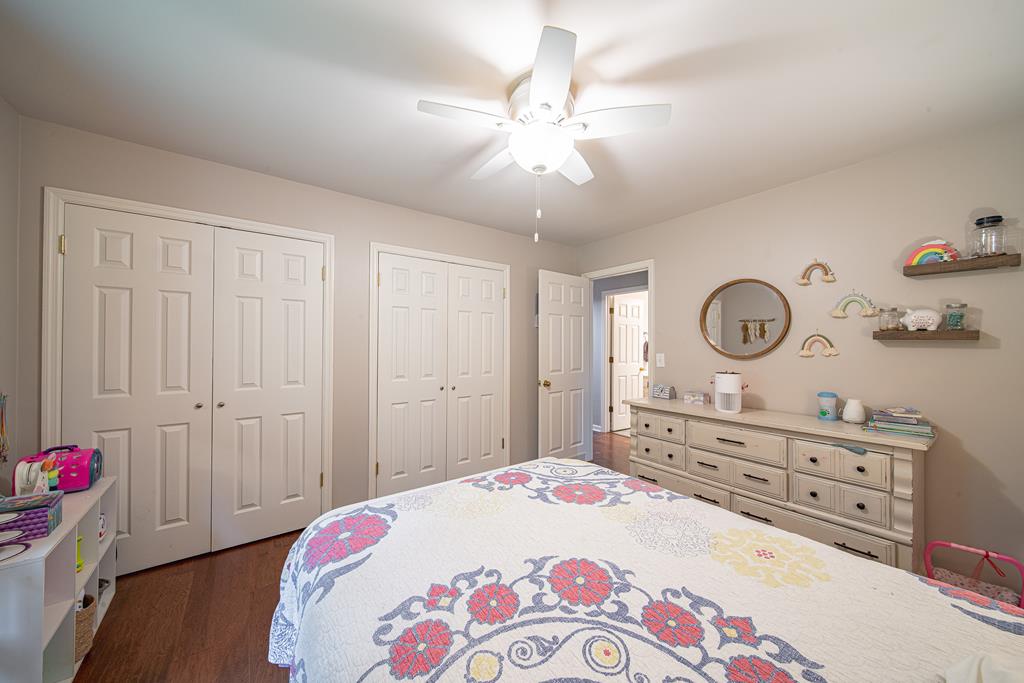 111 Stoneridge Road Cataula, GA 31804 - Photo 35 of 45 a bedroom with a bed and a chandelier