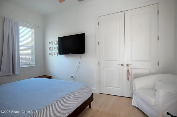 a bedroom with a bed and a flat screen tv