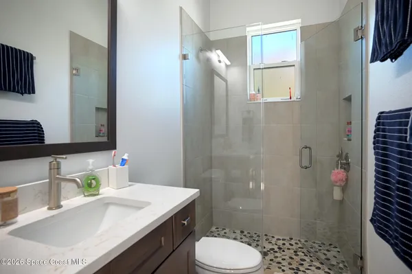 a bathroom with a sink toilet and shower