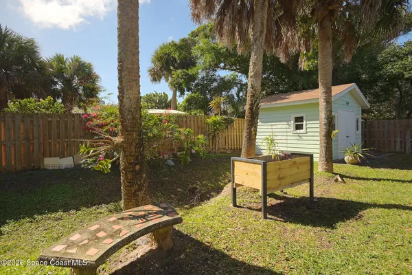 a backyard of a house with yard and outdoor seating