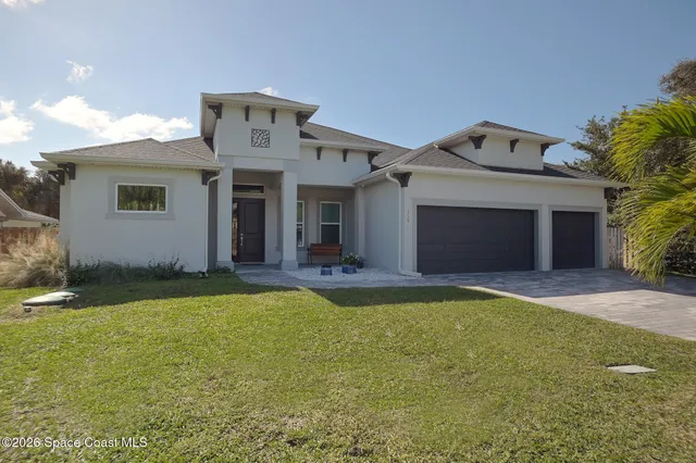 a front view of a house with yard and garage