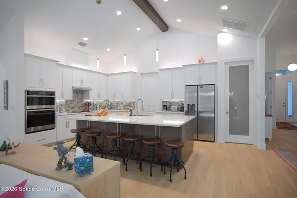 a kitchen with stainless steel appliances kitchen island granite countertop a sink and cabinets