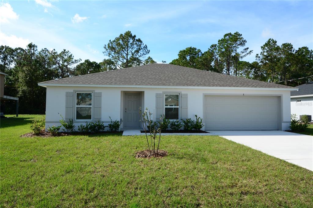 8 Sea Flower Path Palm Coast, FL 32164 - Photo 1 of 30 a front view of house with yard and green space