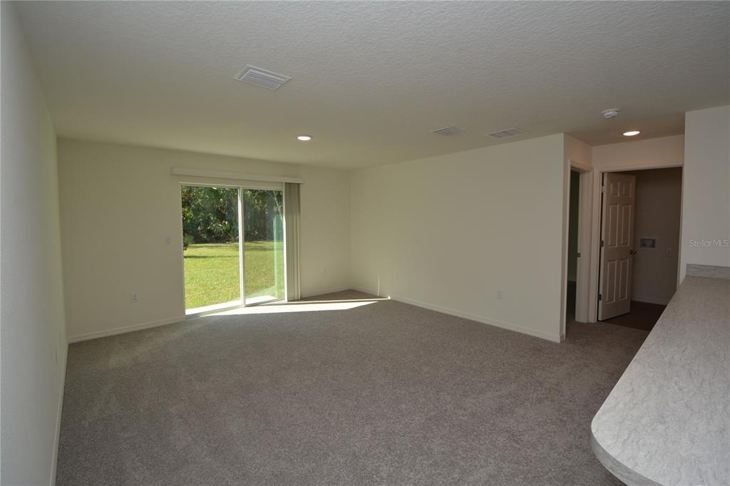 8 Sea Flower Path Palm Coast, FL 32164 - Photo 12 of 30 a view of an empty room with a window