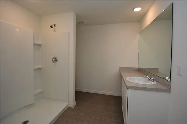 a bathroom with a sink and shower