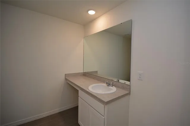 a bathroom with a sink and mirror