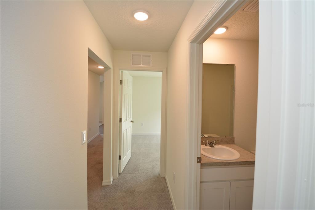 8 Sea Flower Path Palm Coast, FL 32164 - Photo 24 of 30 a bathroom with a sink and mirror with toilet