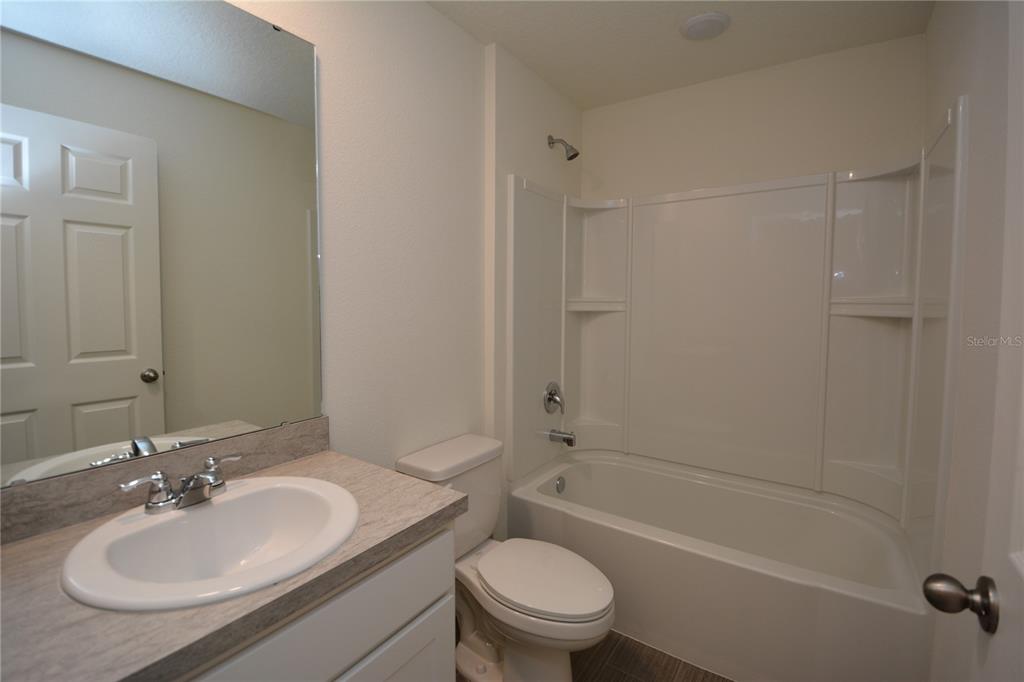 8 Sea Flower Path Palm Coast, FL 32164 - Photo 30 of 30 a bathroom with a sink toilet tub vanity and shower