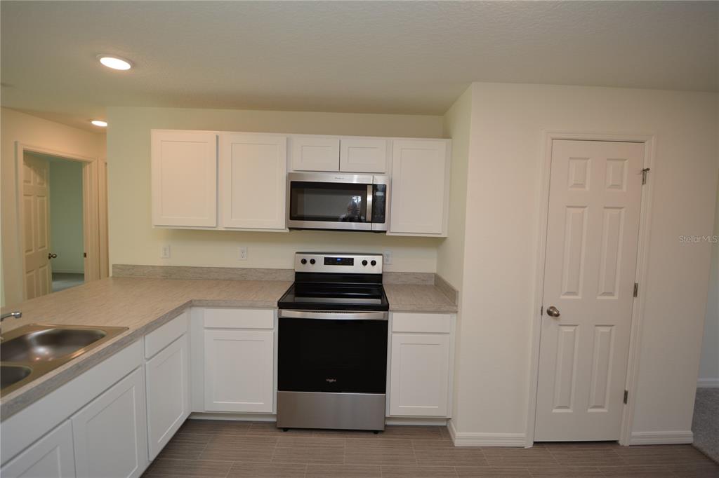 8 Sea Flower Path Palm Coast, FL 32164 - Photo 7 of 30 a kitchen with sink a microwave and cabinets