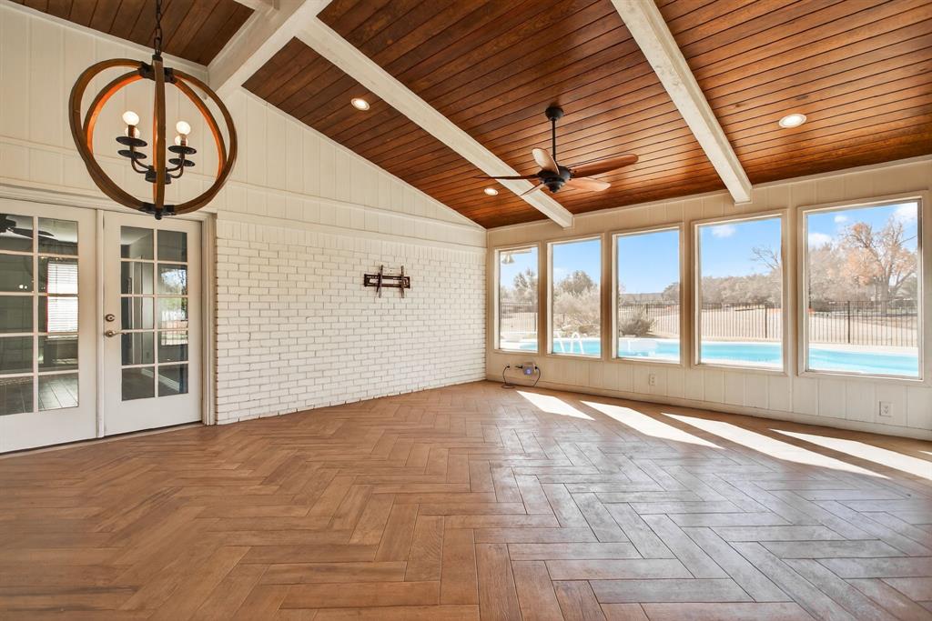 7117 Serrano Drive Benbrook, TX 76126 - Photo 25 of 26 Unfurnished sunroom featuring french doors, parquet floors, brick wall, lofted ceiling with beams, and wood ceiling