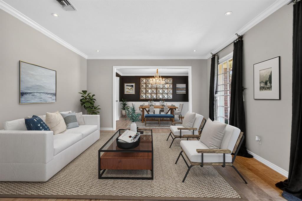 7117 Serrano Drive Benbrook, TX 76126 - Photo 3 of 26 Living area with a chandelier, wood finished floors, and ornamental molding