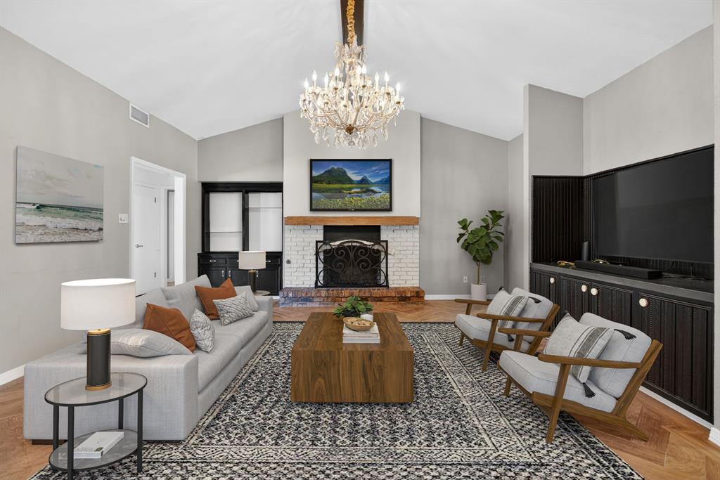 7117 Serrano Drive Benbrook, TX 76126 - Photo 6 of 26 Living area featuring parquet floors, a chandelier, and a brick fireplace