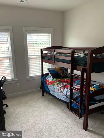 a bathroom with double sink and a mirror