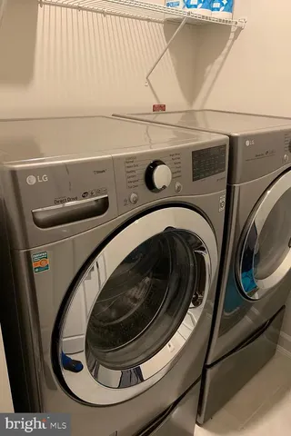 a living room with fireplace furniture and a large window