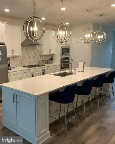 a large kitchen with a table and chairs