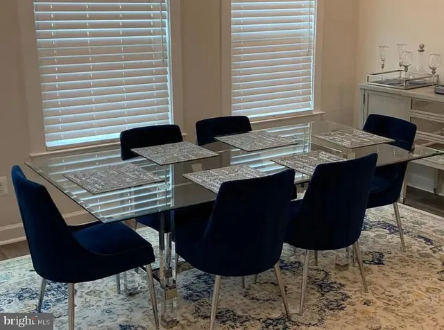 a bathroom with a granite countertop sink a toilet a mirror and shower