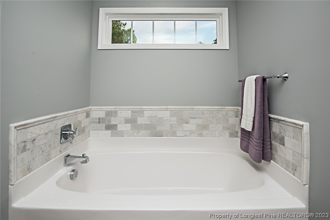 341 Solomon Drive Cameron, NC 28326 - Photo 13 of 21 a bath tub sitting next to a window