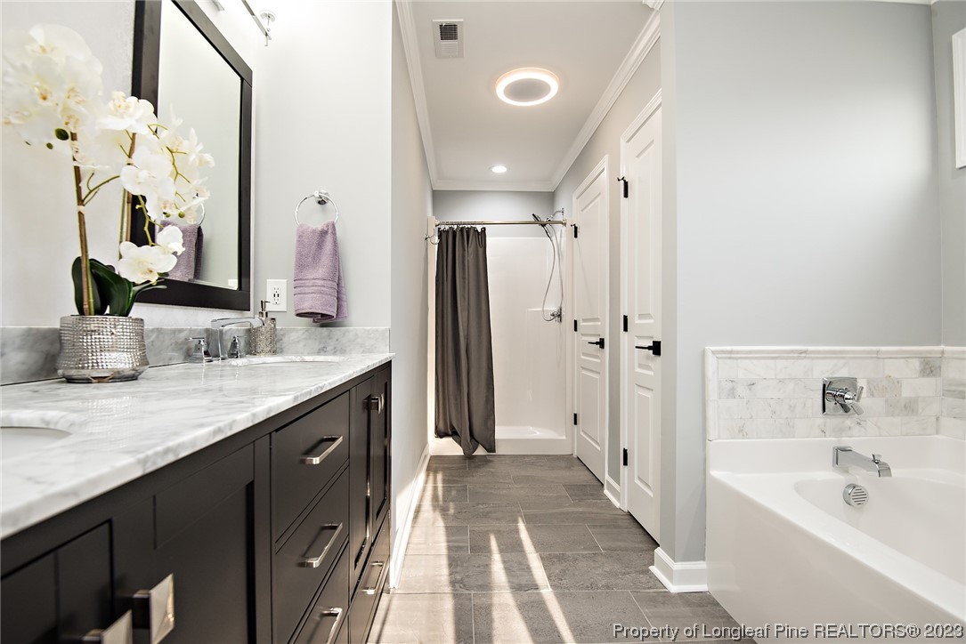 341 Solomon Drive Cameron, NC 28326 - Photo 14 of 21 a spacious bathroom with a granite countertop sink a toilet a shower and a mirror