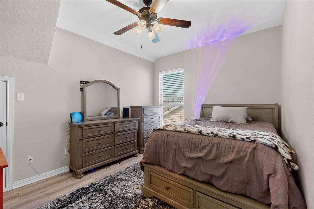 7625 Ridgedale Court Sachse, TX 75048 - Photo 26 of 40 upstairs, Bedroom featuring ceiling fan, wood tiled floors, and vaulted ceiling