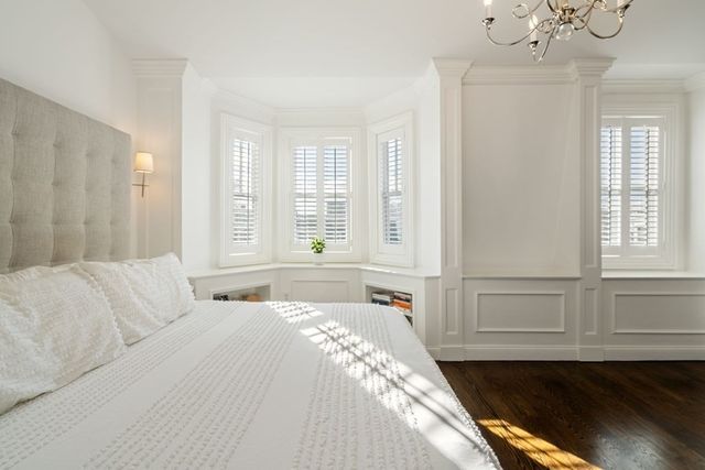 a spacious bedroom with a bed and a window