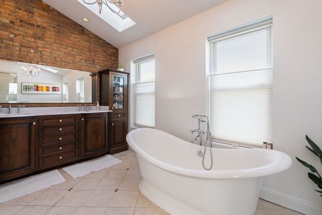 a spacious bathroom with a bathtub and sink
