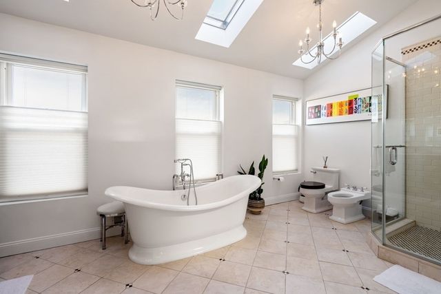 a white bath tub sitting next to a white toilet