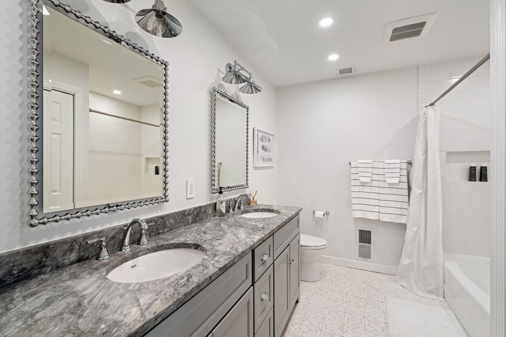 112 West 3rd Street Boston, MA 02127 - Photo 24 of 33 a bathroom with a granite countertop sink a toilet a mirror and shower