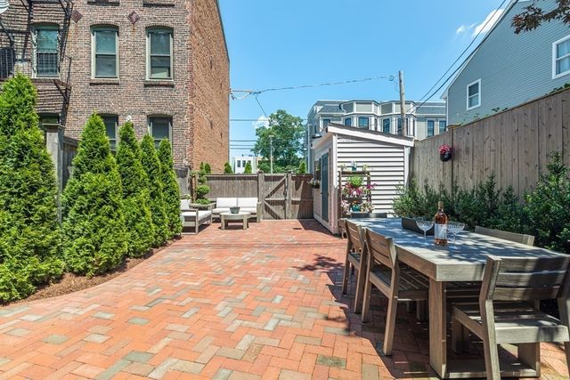 a view of a house with backyard and sitting area