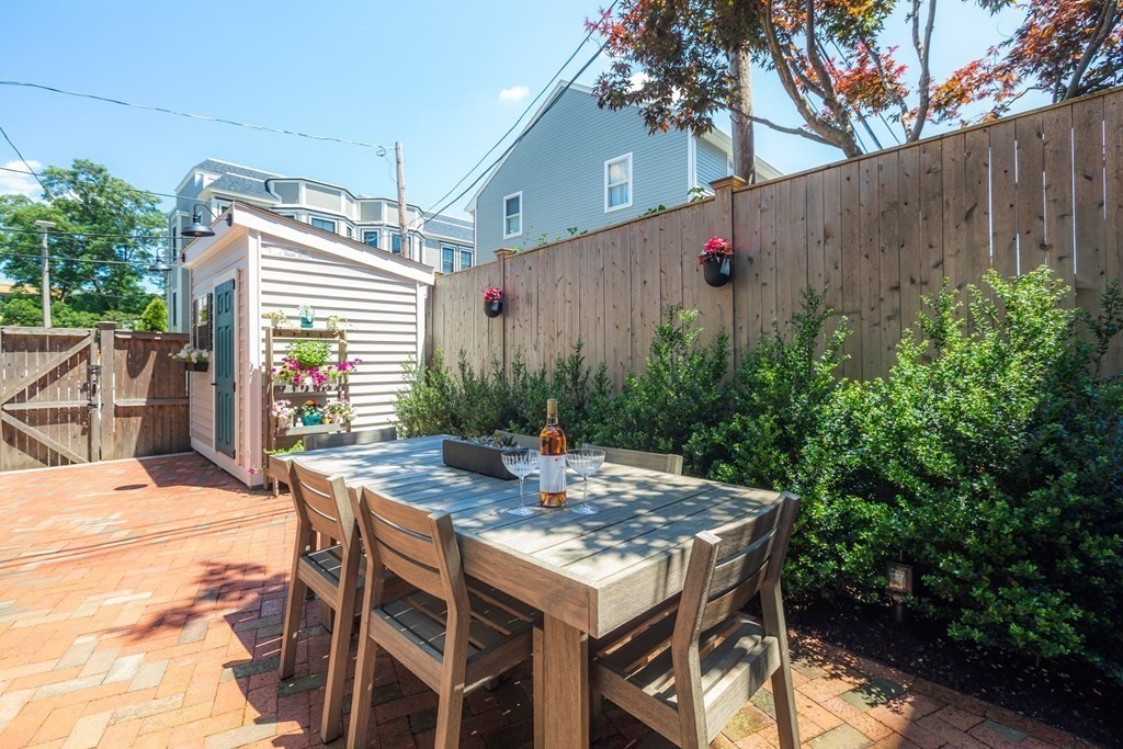 112 West 3rd Street Boston, MA 02127 - Photo 27 of 33 a patio with table and chairs and potted plants