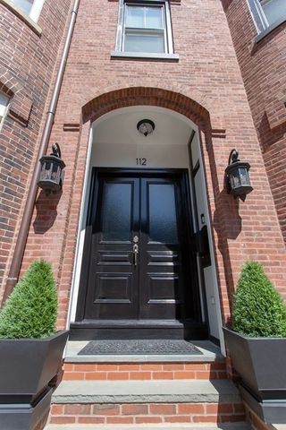 a car parked in front of a brick building