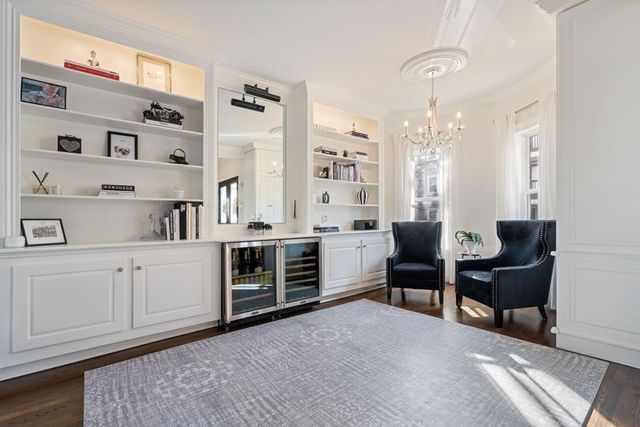 a spacious bedroom with furniture and a dresser