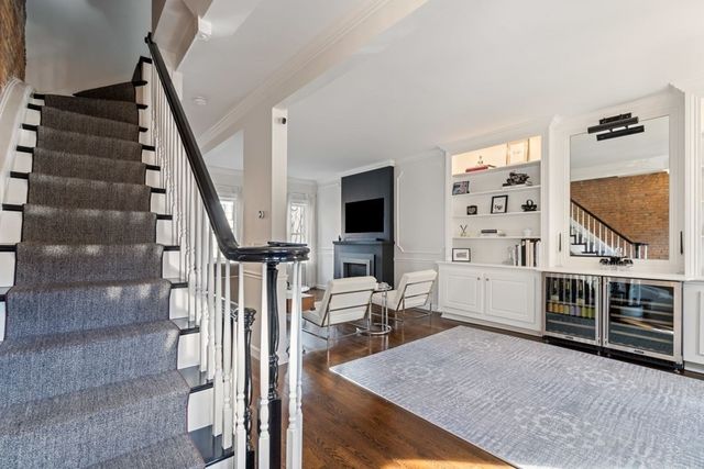 a view of a livingroom with furniture and staircase