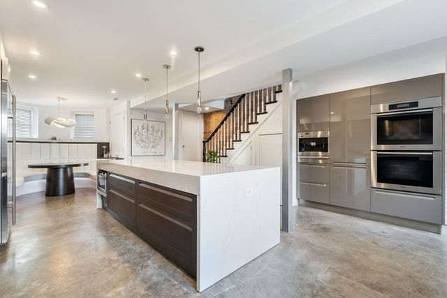a kitchen with stainless steel appliances kitchen island wooden cabinets and granite counter tops