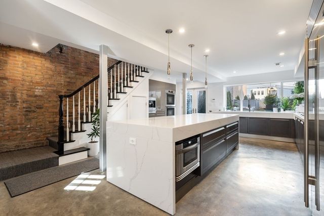a kitchen with stainless steel appliances kitchen island a cabinets and a counter top space
